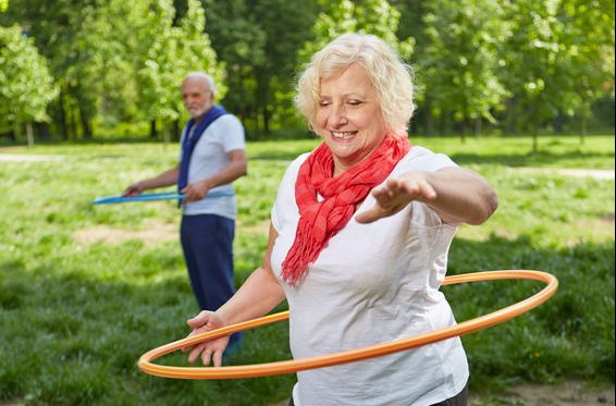 47618043 - two happy senior people using hoops in a park for a fitness training